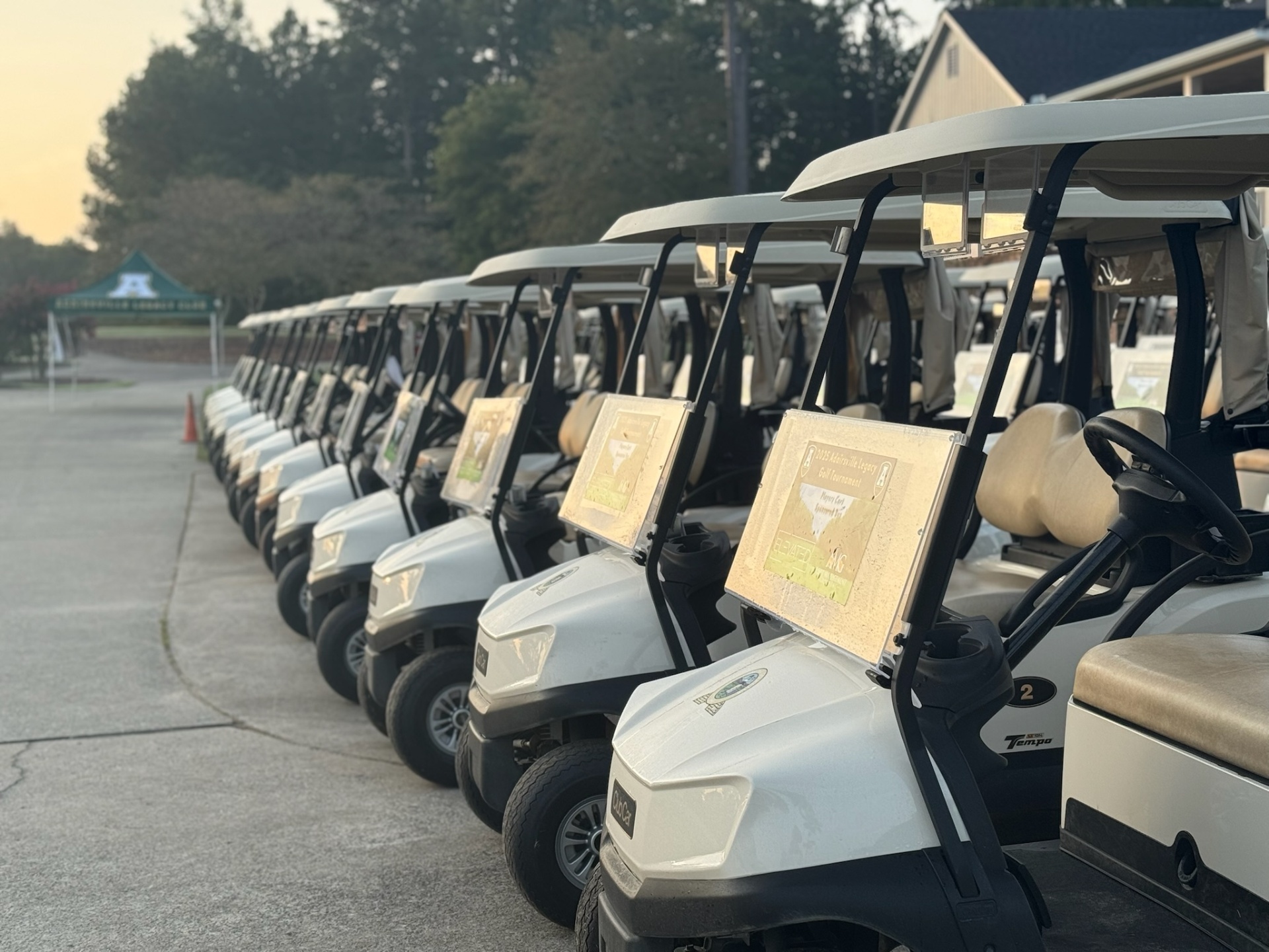 Row of golf carts lined up at sunrise for the Adairsville Legacy Golf Tournament